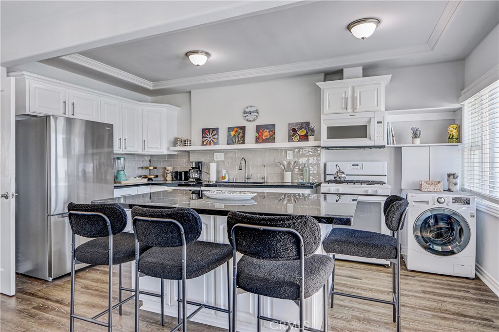 230 40th Street, Unit 1 Manhattan Beach, CA 90266 - Photo 5 of 19 a kitchen with stainless steel appliances granite countertop a white cabinets and a stove top oven