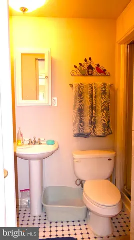 a bathroom with a toilet sink and mirror