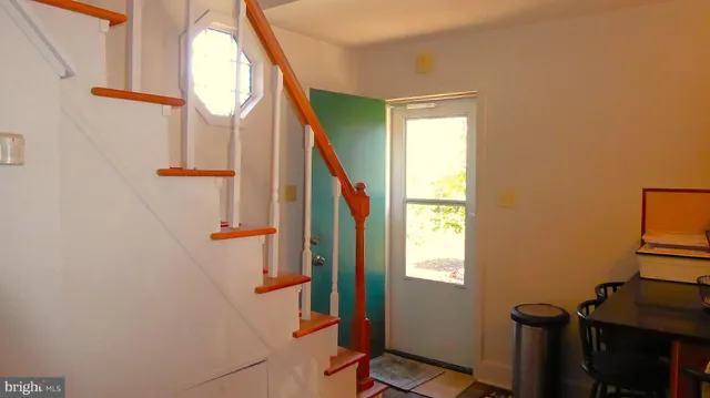 a view of an entryway with wooden floor