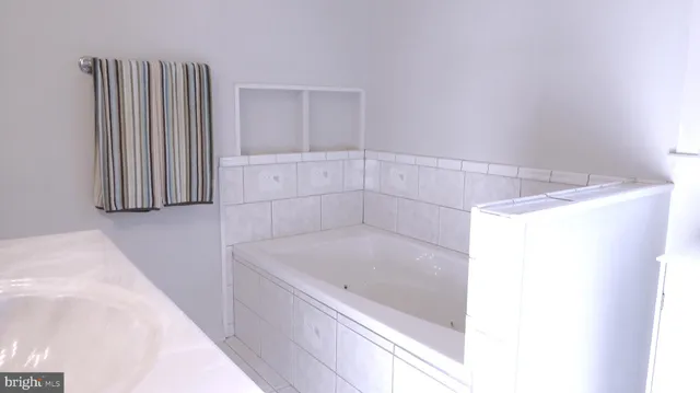 a bathroom with a bathtub and shower