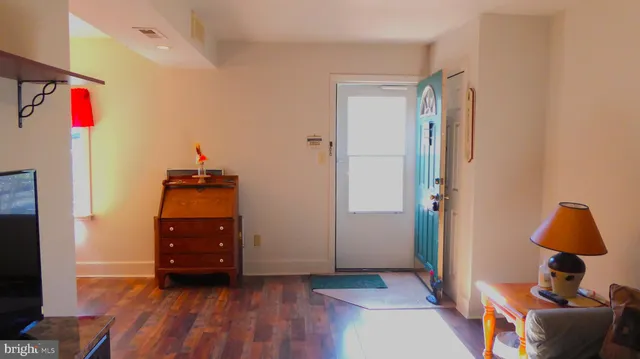 a view of room with furniture and wooden floor