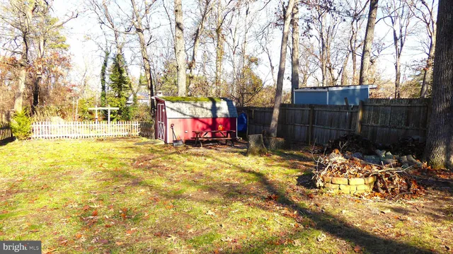 a view of yard with wooden fence