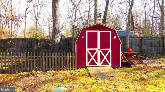 a view of wooden fence and a sign of the house