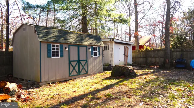 a backyard of a house with yard and outdoor seating