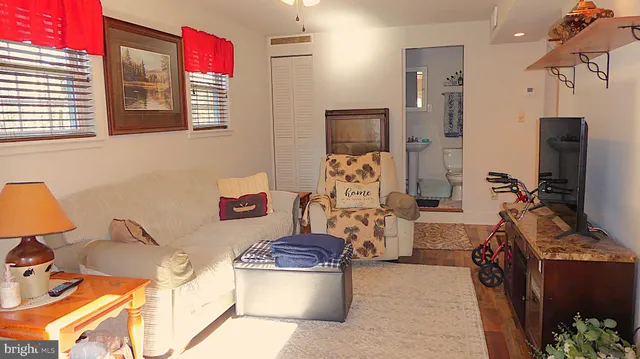 a room with furniture a flat screen tv and a window