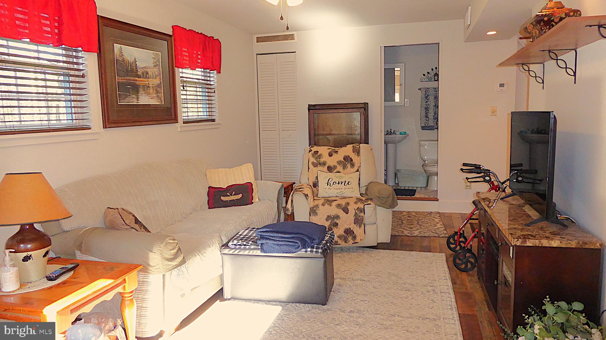 110 Daffodil Road Millville, NJ 08332 - Photo 5 of 37 a room with furniture a flat screen tv and a window