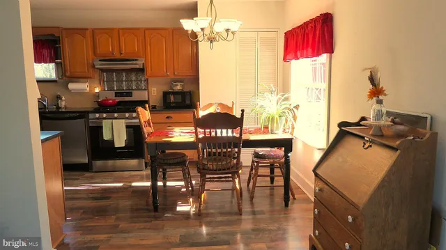 a dining room with furniture window and wooden floor