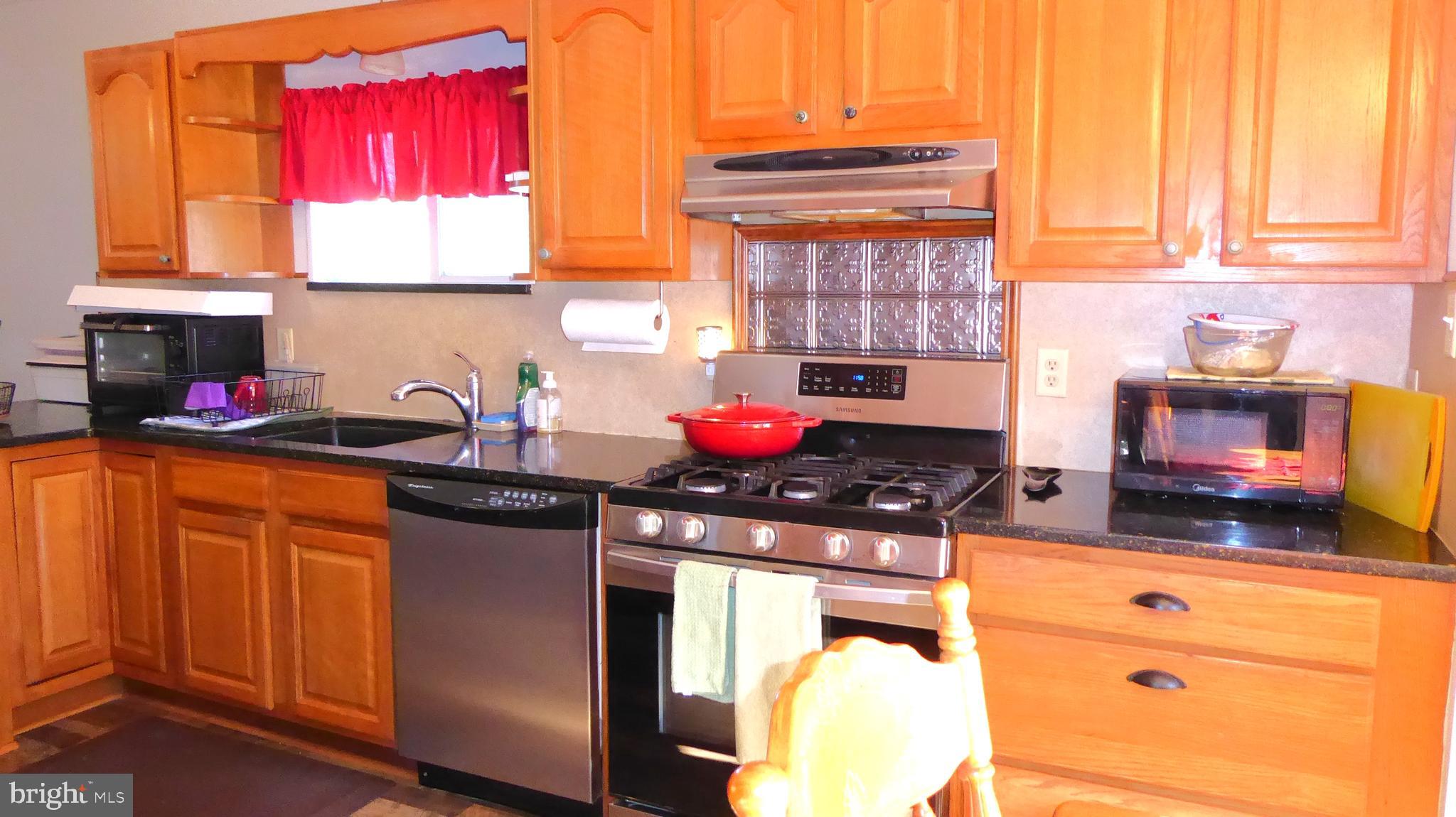 110 Daffodil Road Millville, NJ 08332 - Photo 9 of 37 a kitchen with stainless steel appliances granite countertop a stove a sink and a microwave