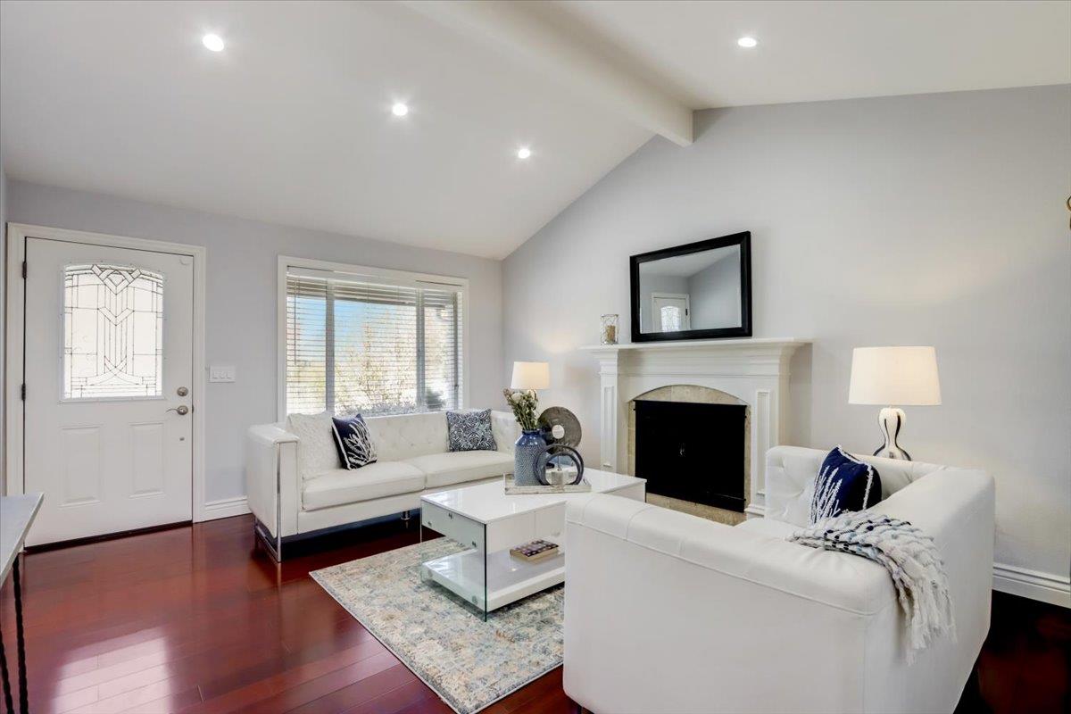 2284 Fallingtree Drive San Jose, CA 95131 - Photo 2 of 32 a living room with furniture a fireplace and a table