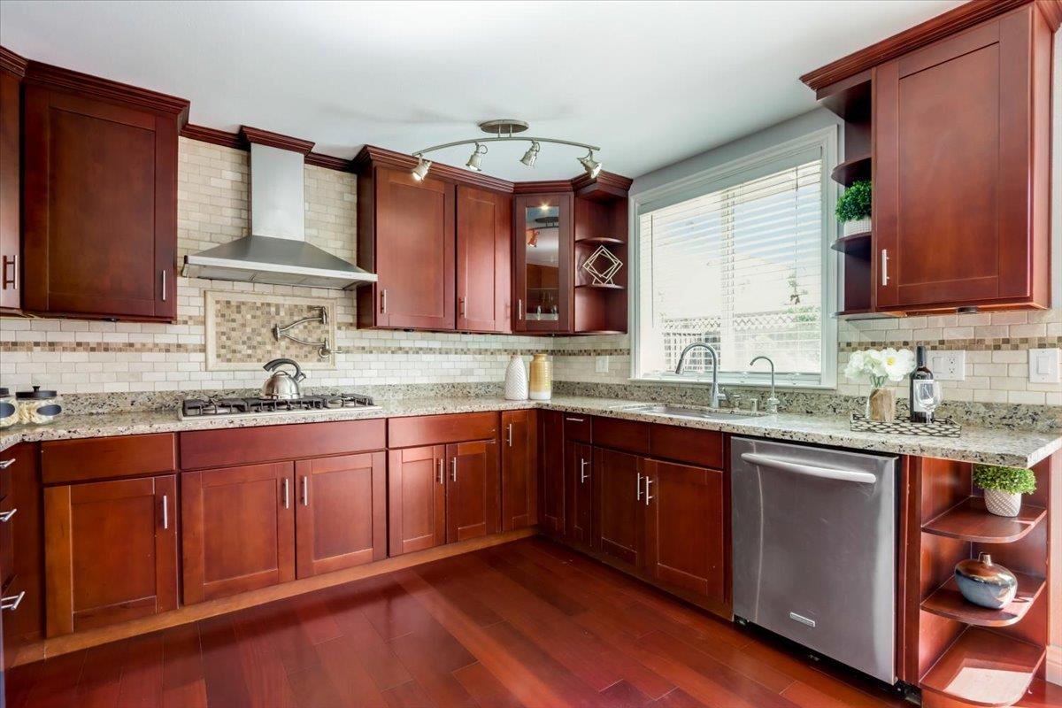 2284 Fallingtree Drive San Jose, CA 95131 - Photo 4 of 32 a kitchen with granite countertop stainless steel appliances a sink and wooden cabinets