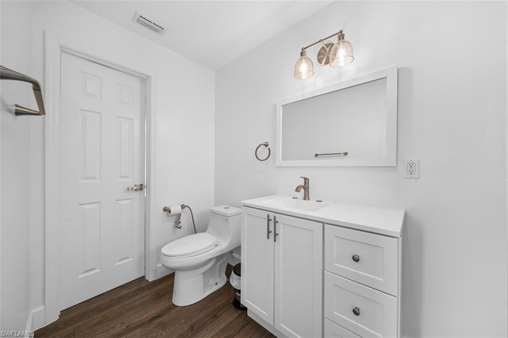 5460 Bayshore Road North Fort Myers, FL 33917 - Photo 4 of 14 a bathroom with a toilet a sink and mirror