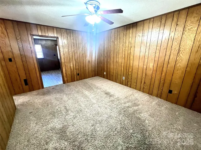 an empty room with closet and wooden floor
