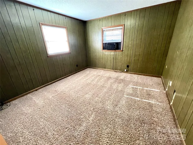a view of an empty room and wooden door