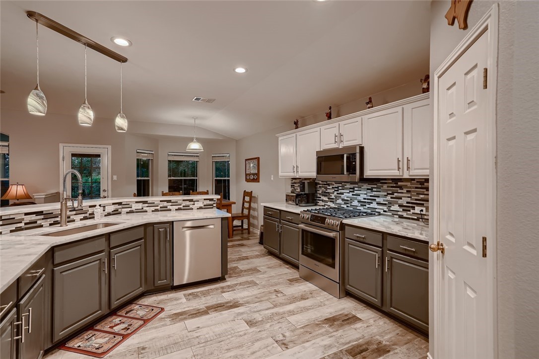 3517 Fitzroy Avenue Austin, TX 78748 - Photo 1 of 1 a large kitchen with stainless steel appliances granite countertop a stove and a sink