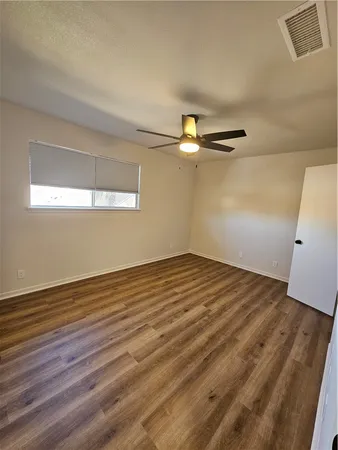 a view of a room with wooden floor