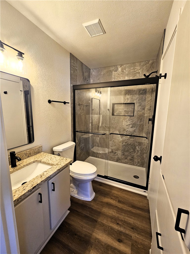 4802 Delwood Street, Unit 3 Corpus Christi, TX 78413 - Photo 15 of 22 a bathroom with a granite countertop sink toilet and shower