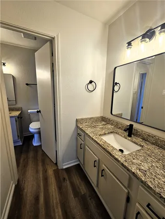 a bathroom with a granite countertop sink and a mirror
