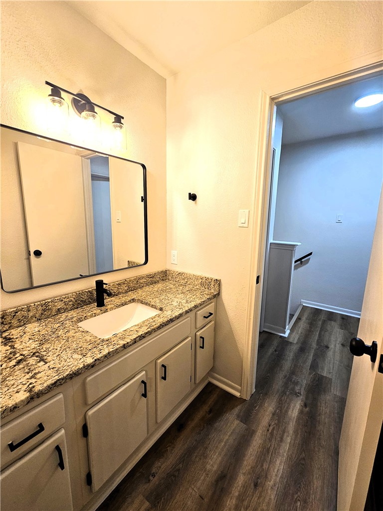 4802 Delwood Street, Unit 3 Corpus Christi, TX 78413 - Photo 17 of 22 a bathroom with a granite countertop sink and a mirror