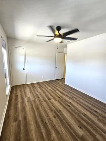 a view of a room with a ceiling fan
