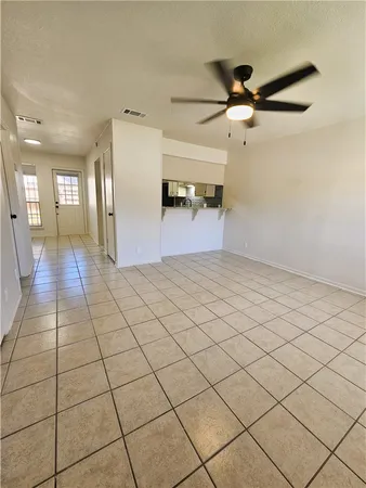 a view of a livingroom with wooden floor and a ceiling fan