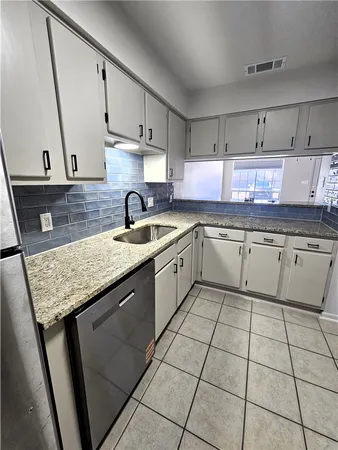 a kitchen with stainless steel appliances granite countertop a sink stove and cabinets