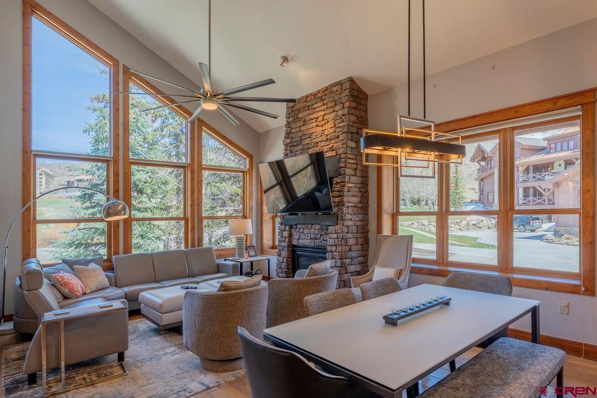 9 Hunter Hill Road, Unit 208 Crested Butte, CO 81225 - Photo 12 of 45 a living room with fireplace furniture and a large window
