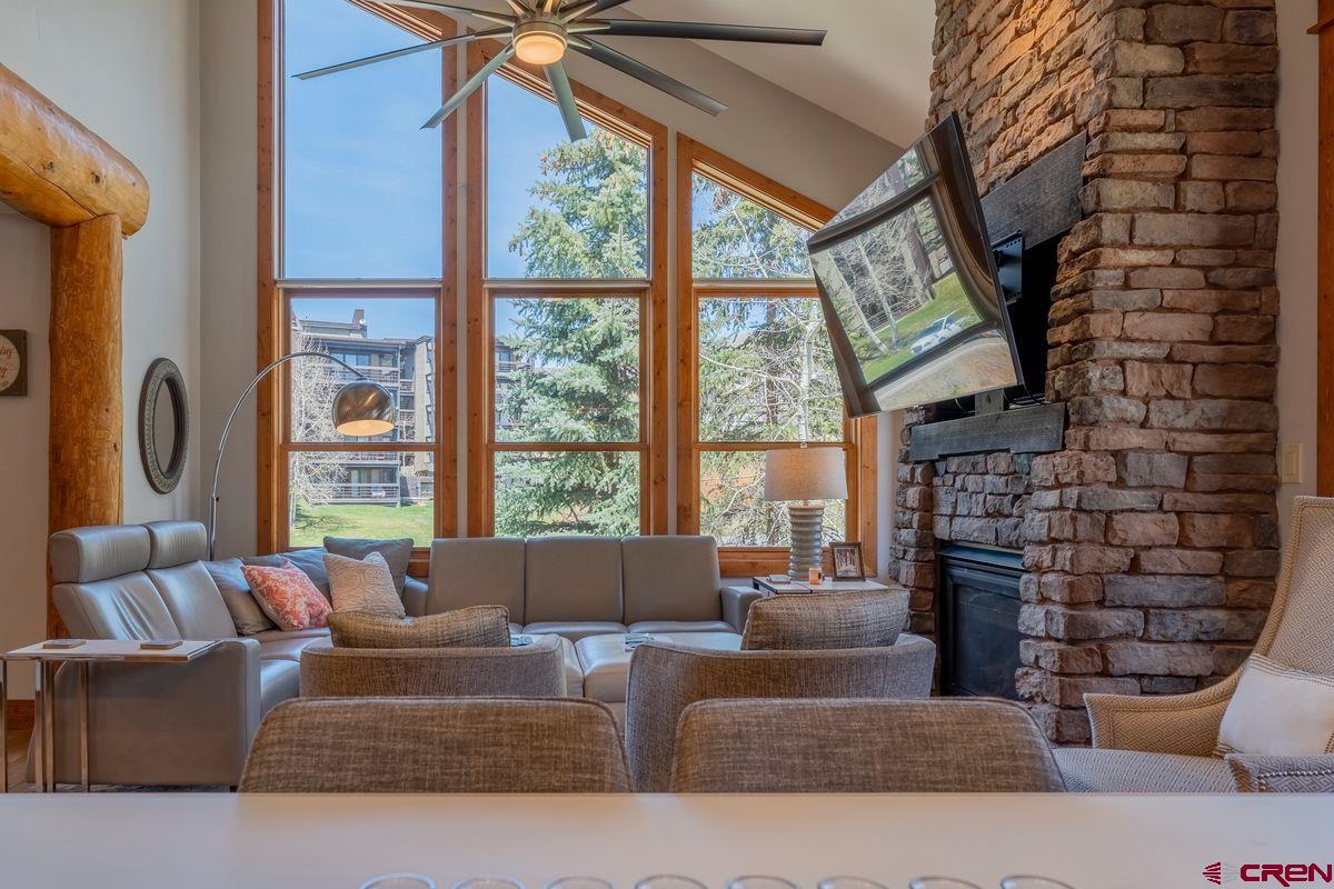 9 Hunter Hill Road, Unit 208 Crested Butte, CO 81225 - Photo 13 of 45 a living room with fireplace furniture and a large window