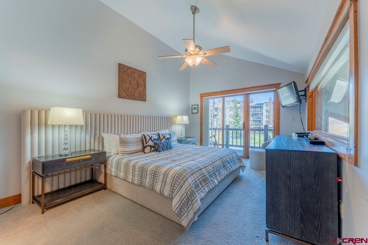 9 Hunter Hill Road, Unit 208 Crested Butte, CO 81225 - Photo 19 of 45 a bedroom with a bed chandelier and a window