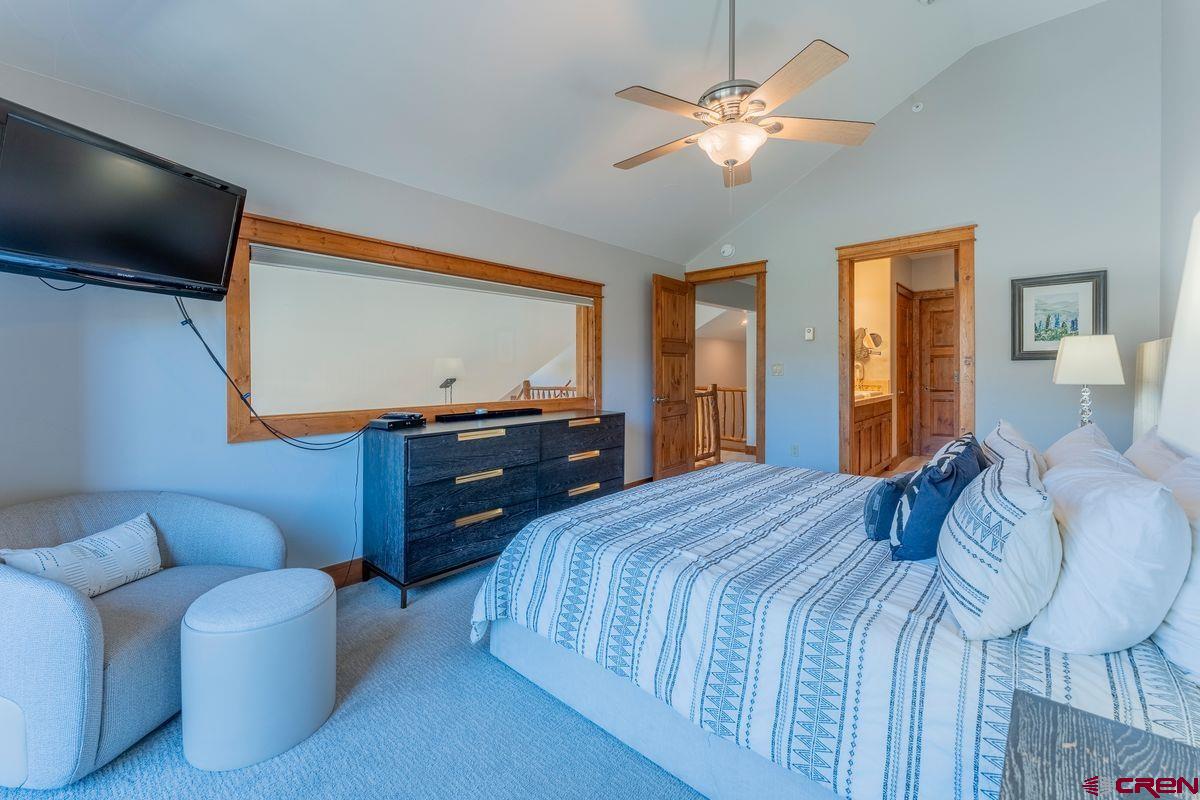 9 Hunter Hill Road, Unit 208 Crested Butte, CO 81225 - Photo 20 of 45 a bedroom with a bed and a dresser with mirror