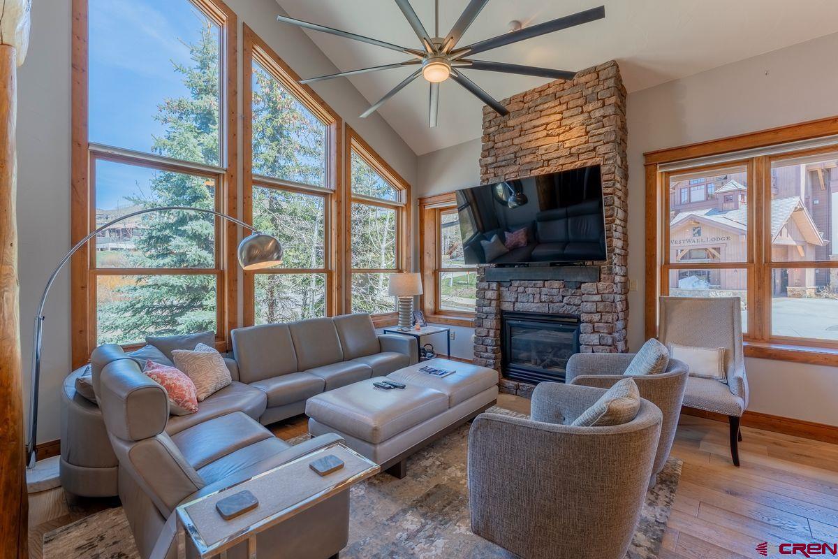 9 Hunter Hill Road, Unit 208 Crested Butte, CO 81225 - Photo 2 of 45 a living room with fireplace furniture and a flat screen tv