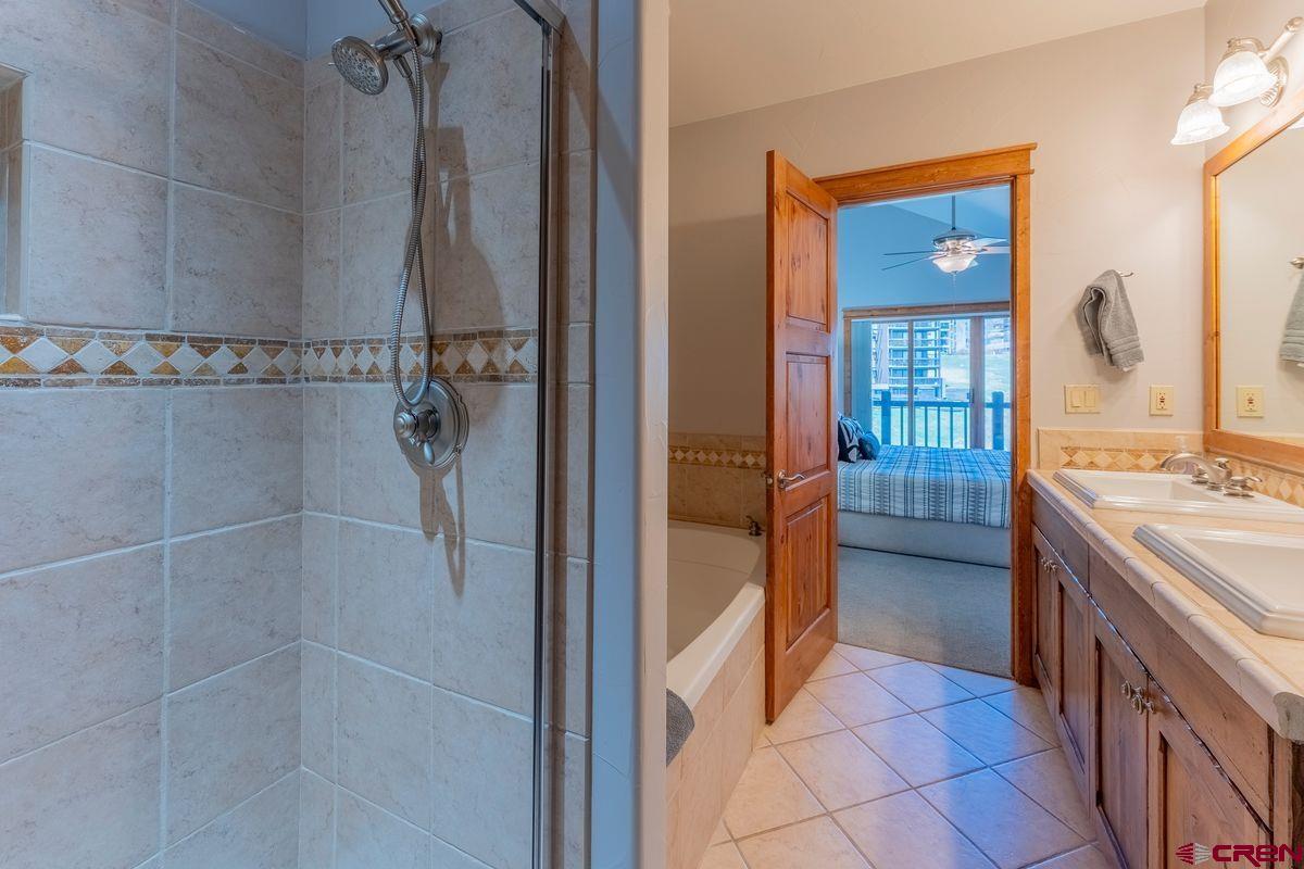 9 Hunter Hill Road, Unit 208 Crested Butte, CO 81225 - Photo 22 of 45 a spacious bathroom with a shower and a sink