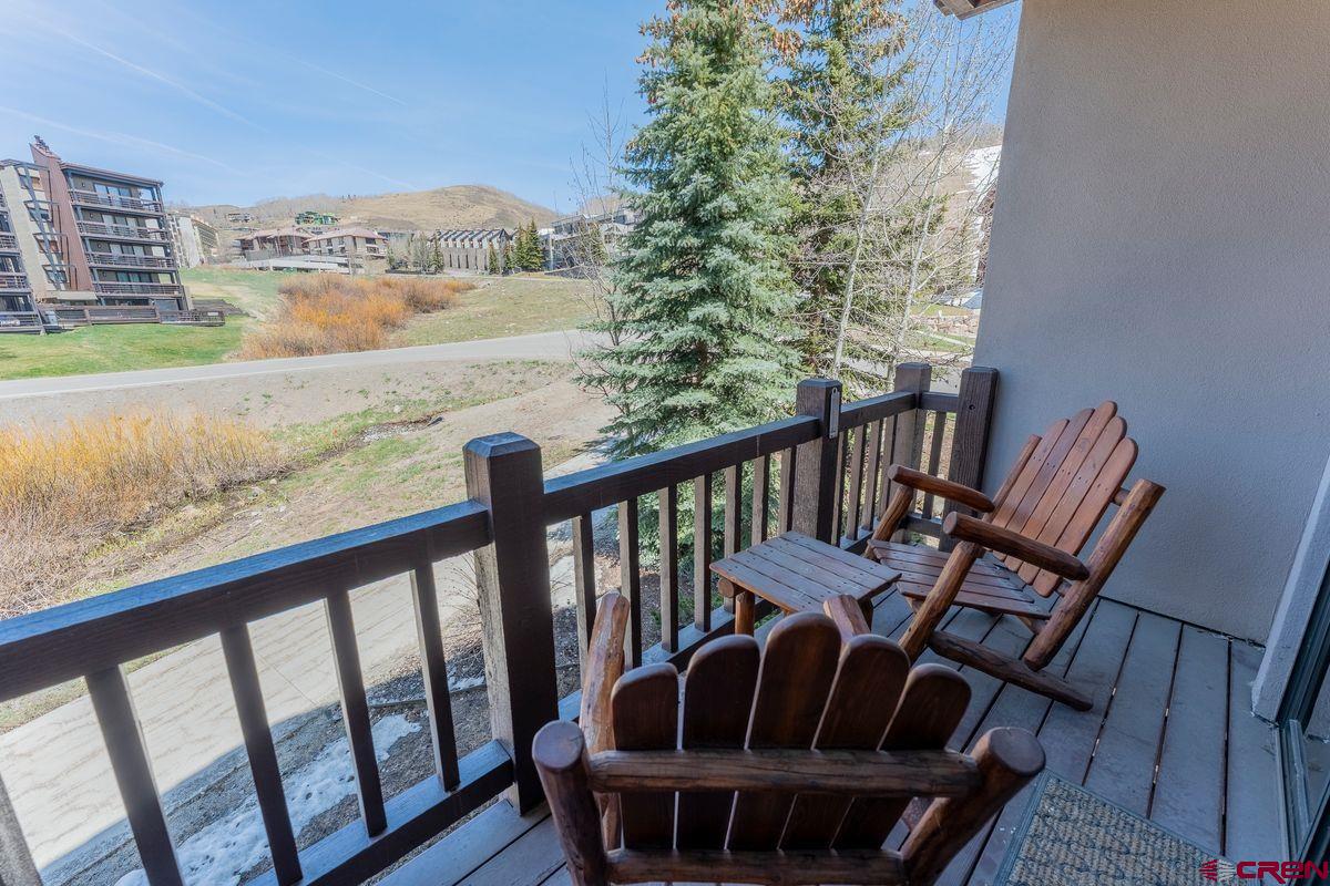 9 Hunter Hill Road, Unit 208 Crested Butte, CO 81225 - Photo 23 of 45 a view of a balcony with chair and wooden floor