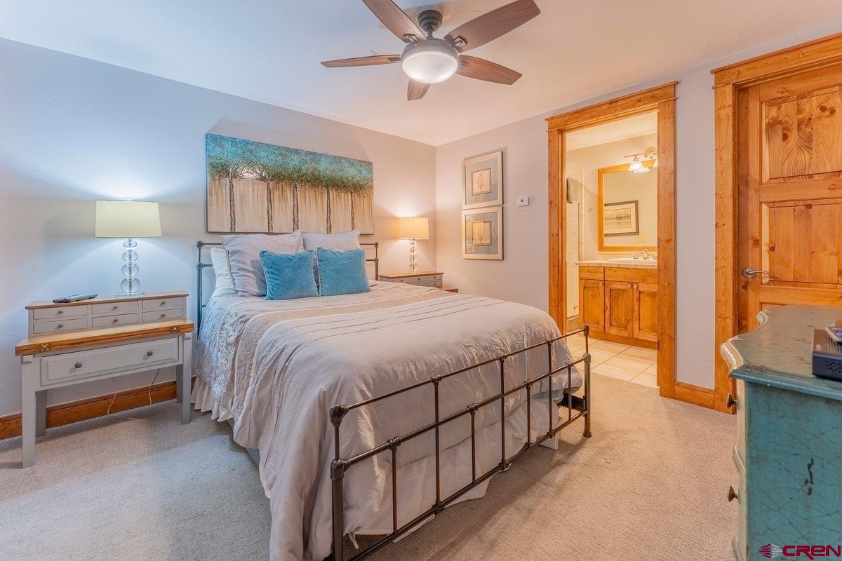 9 Hunter Hill Road, Unit 208 Crested Butte, CO 81225 - Photo 25 of 45 a bedroom with a bed and a chandelier
