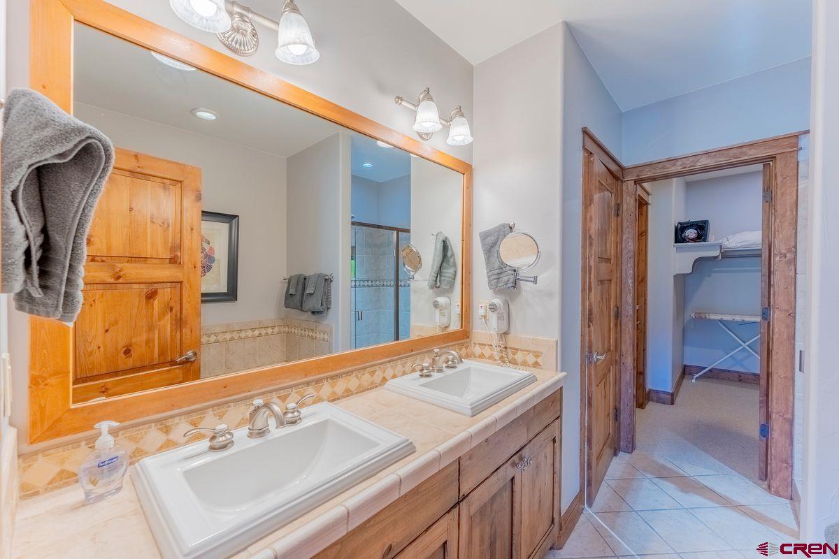 9 Hunter Hill Road, Unit 208 Crested Butte, CO 81225 - Photo 26 of 45 a spacious bathroom with a sink and a mirror