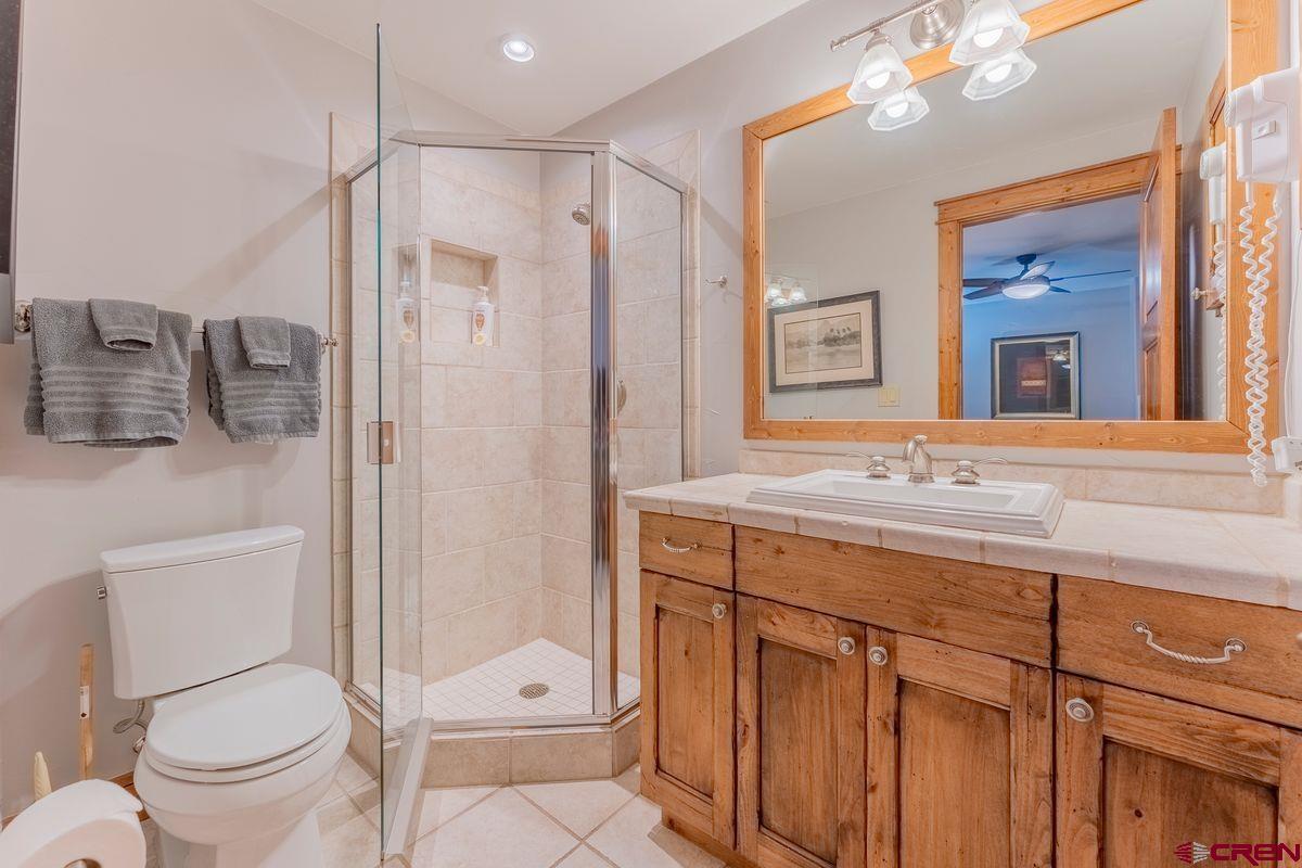 9 Hunter Hill Road, Unit 208 Crested Butte, CO 81225 - Photo 27 of 45 a bathroom with a granite countertop sink toilet and shower