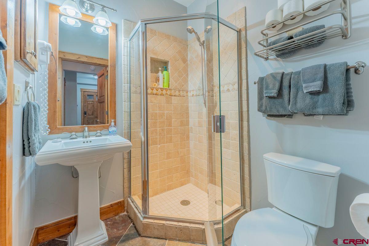 9 Hunter Hill Road, Unit 208 Crested Butte, CO 81225 - Photo 29 of 45 a bathroom with a granite countertop sink toilet and shower