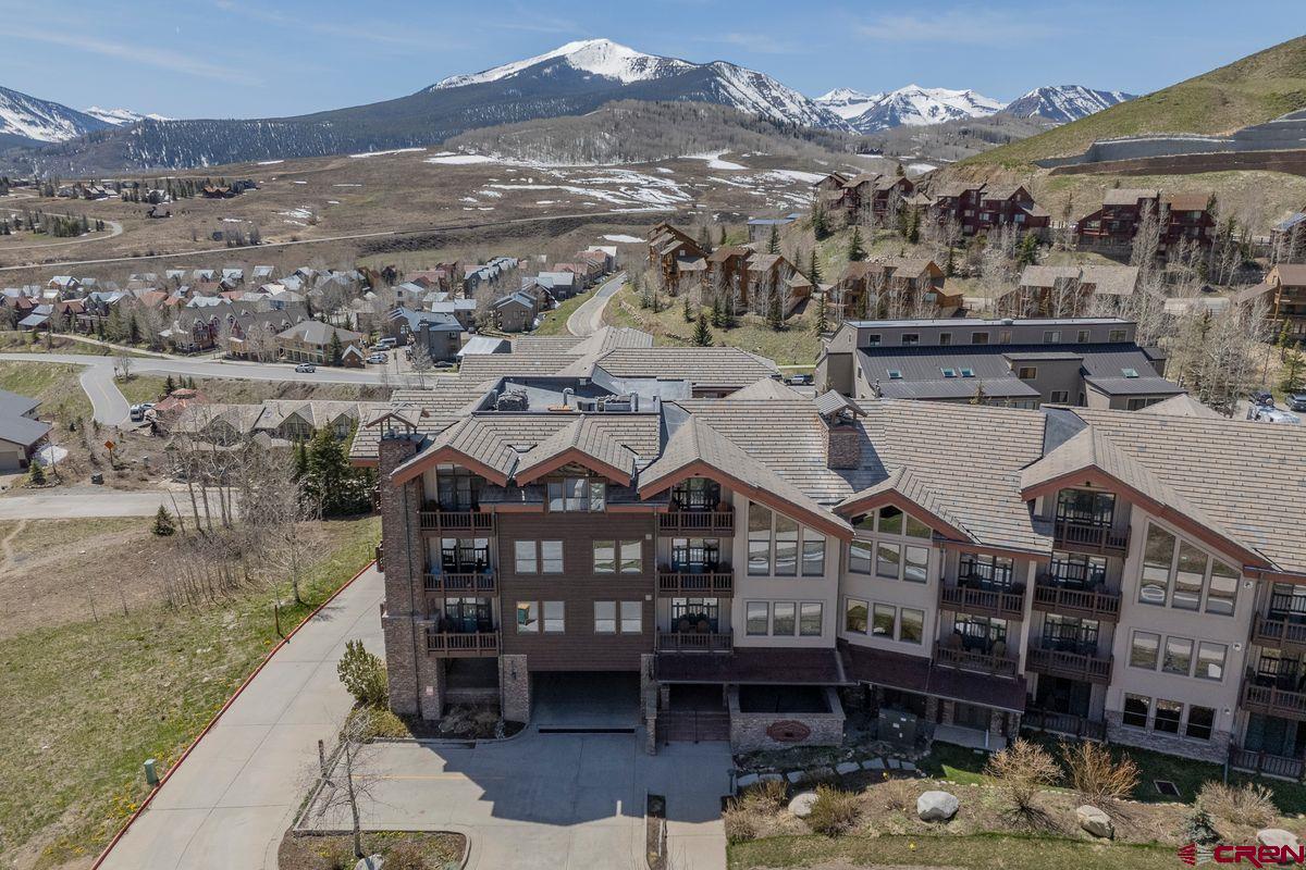 9 Hunter Hill Road, Unit 208 Crested Butte, CO 81225 - Photo 31 of 45 a view of a large building with a mountain in the background