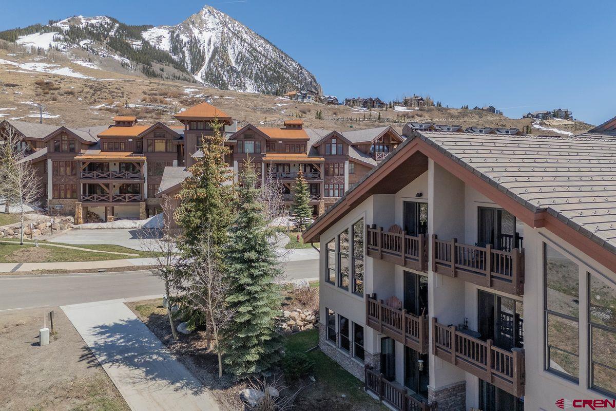 9 Hunter Hill Road, Unit 208 Crested Butte, CO 81225 - Photo 32 of 45 a view of a house with a yard and balcony