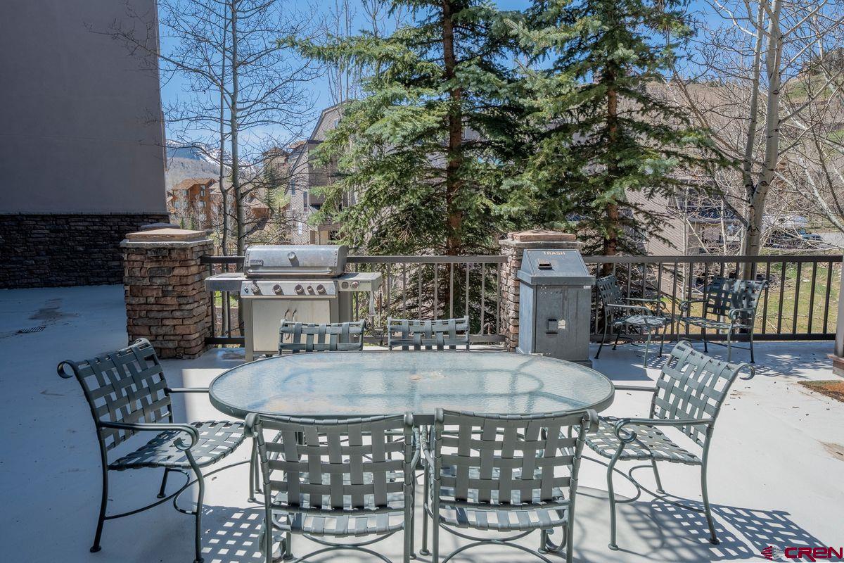 9 Hunter Hill Road, Unit 208 Crested Butte, CO 81225 - Photo 36 of 45 a table and chairs and a fire pit in the patio
