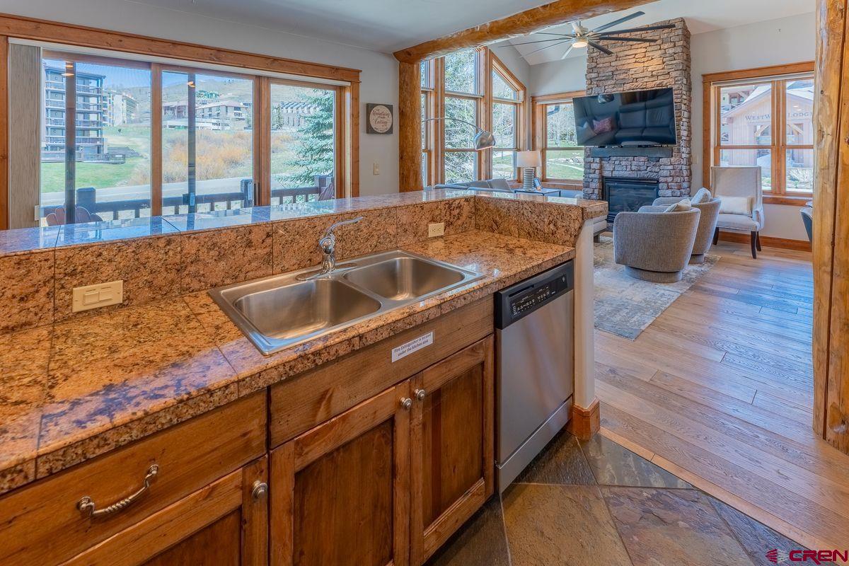 9 Hunter Hill Road, Unit 208 Crested Butte, CO 81225 - Photo 9 of 45 a living room with stainless steel appliances granite countertop a sink and a wooden floor