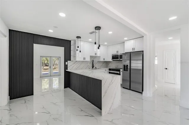 a kitchen with refrigerator and window