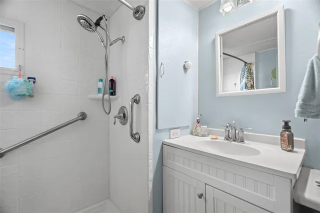 a bathroom with a sink cabinets and a window