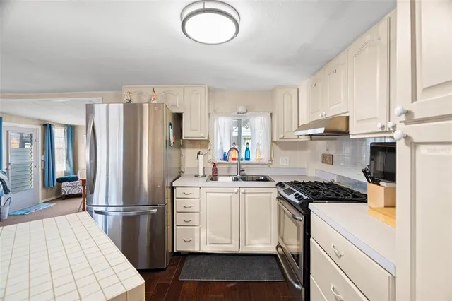 a dining room with furniture a rug and a large window