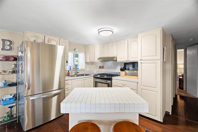 a kitchen with a stove and a refrigerator