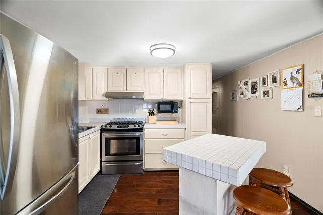 a patio with a table and chairs under an umbrella