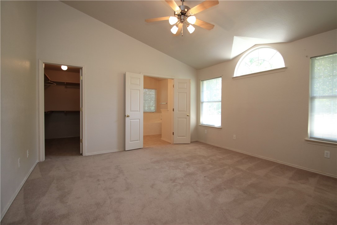 16516 Fowler Mill Cove Austin, TX 78717 - Photo 11 of 27 an empty room with windows and fan