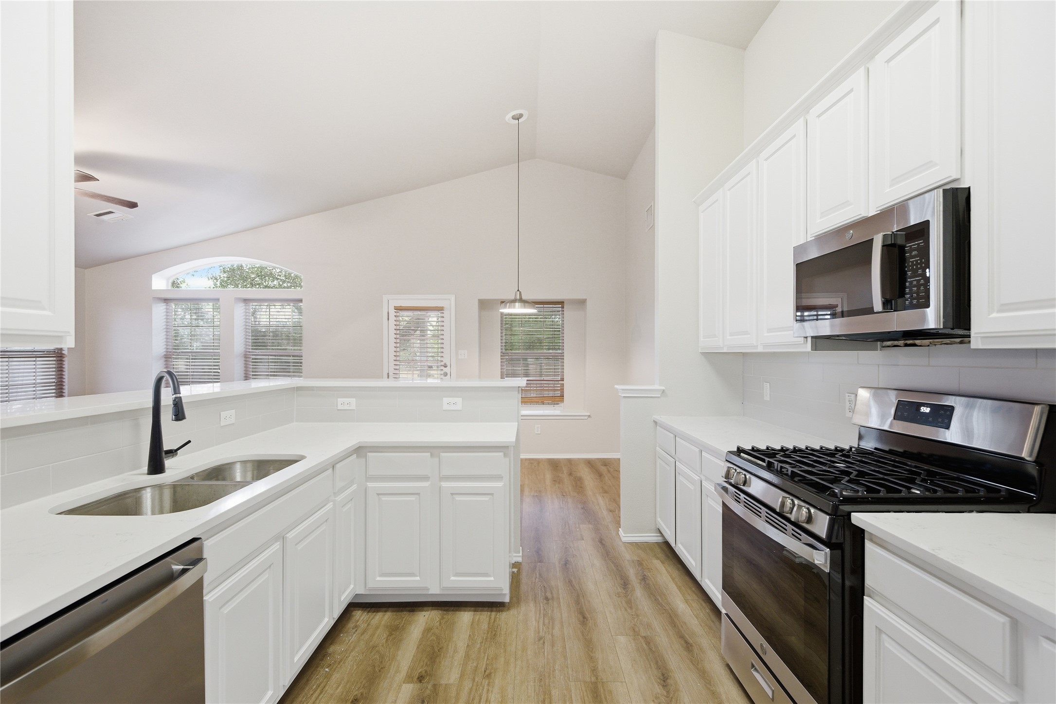 16516 Fowler Mill Cove Austin, TX 78717 - Photo 24 of 37 a kitchen with a sink stove and microwave