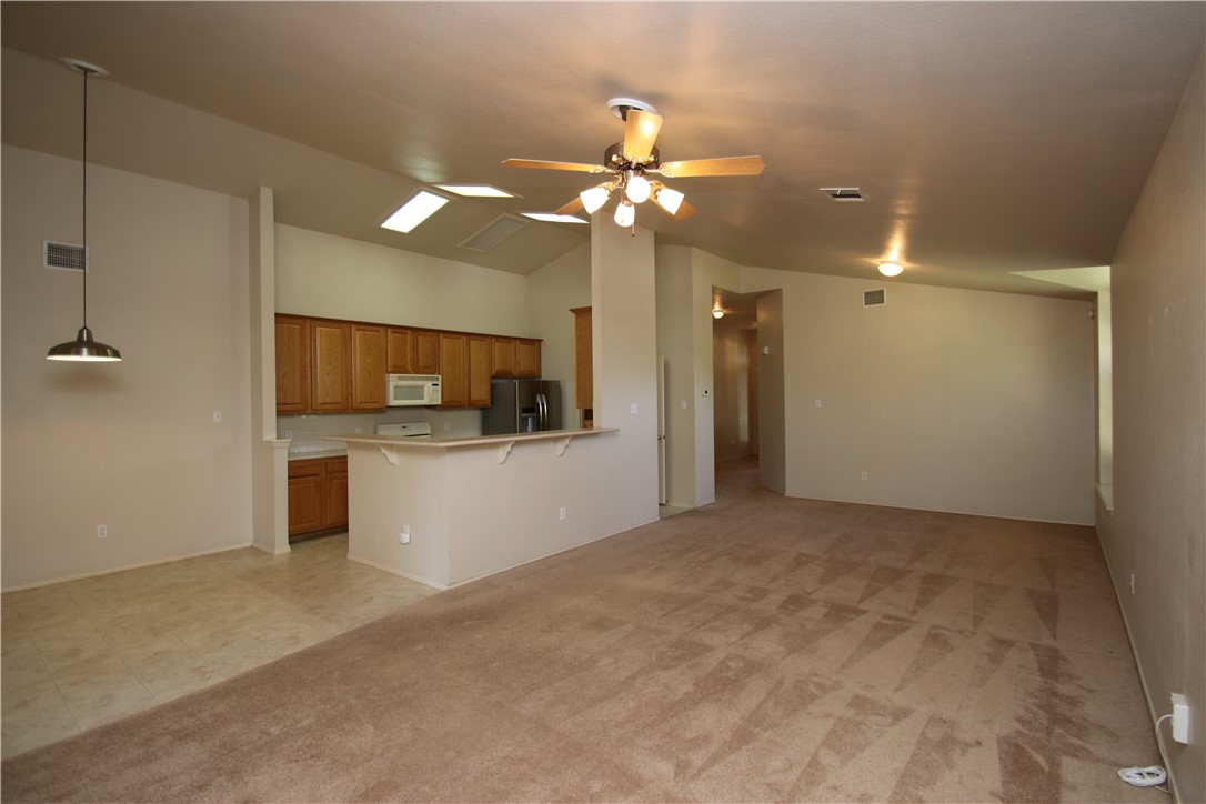 16516 Fowler Mill Cove Austin, TX 78717 - Photo 7 of 27 a view of a kitchen with a sink and dishwasher kitchen appliances