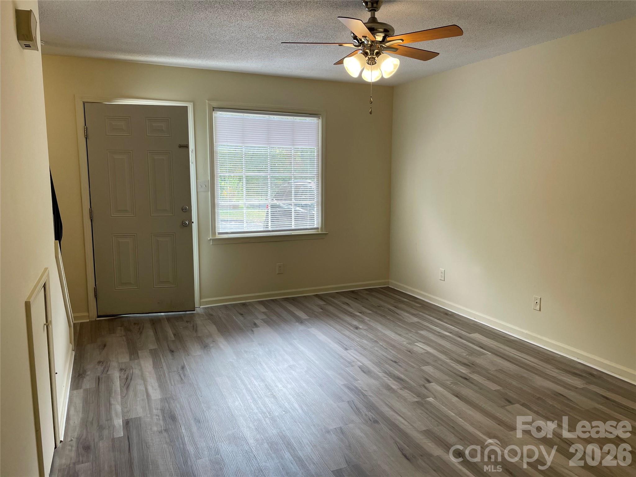 118 Ross Street, Unit A2 Morganton, NC 28655 - Photo 1 of 2 a view of an empty room with wooden floor and a window