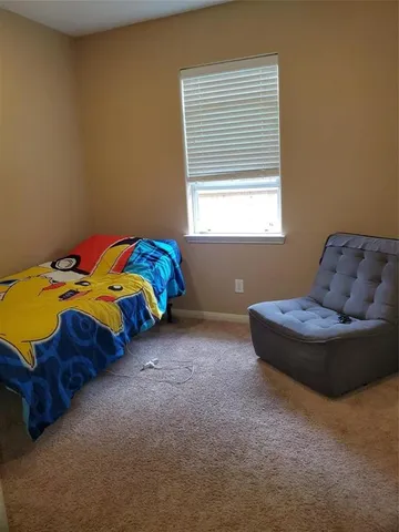 a bedroom with a bed and window